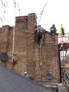 Brickwork repointing being carried out by rope access