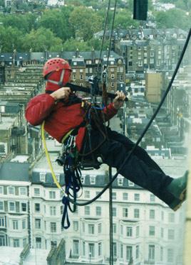 Abseiler jet-washing a commercial building