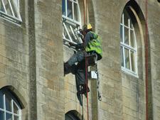 Painting window frames over a river building