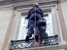 Painting window frames and balconies using rope access