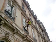Painting window frames and balconies using rope access