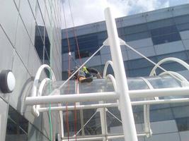 Abseiler cleaning glass entrance canopy